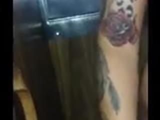 Tattooed brunette enjoys a stranger in the gloryhole